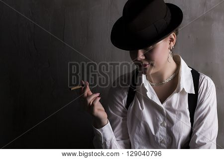 Mysterious beaytiful stranger with cigar in hat