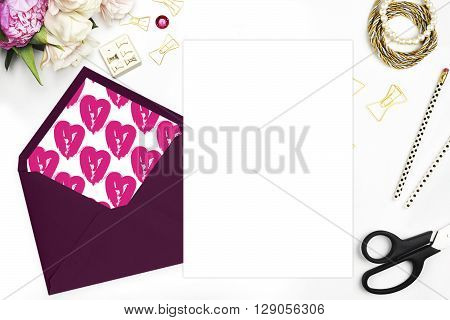 Modern trend template for advertising. Desktop workplace designer, painter top view.
Product mock-up.  Glamour style. Gold and stationery items on white table. Flat lay. Wedding template invitation.