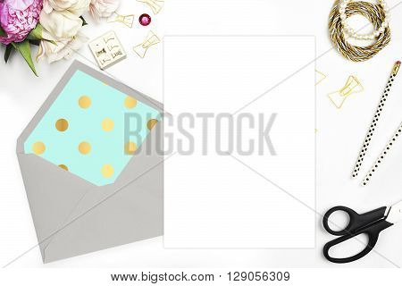 Modern trend template for advertising. Desktop workplace designer, painter top view.
Product mock-up.  Glamour style. Gold and stationery items on white table. Flat lay. Wedding template invitation.