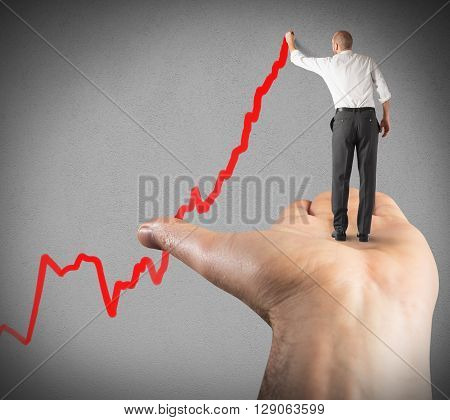 Man draws arrow supported by a hand