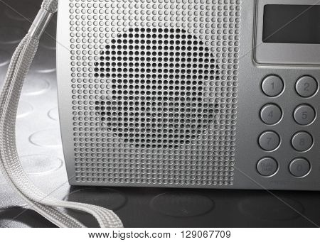 Speaker on front of a portable shortwave radio that runs on batteries