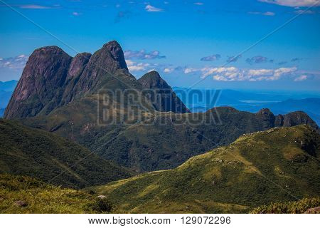 High Mountain peaks and deep green valley with blue sky
