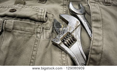 Several tools on a denim workers pocket