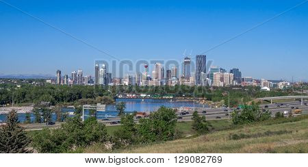 View of the Calgary skyline looking west. Deerfoot trail is in the foreground in front of the Bow River.