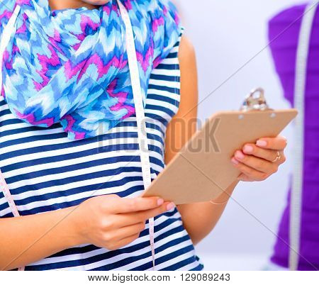 Modern young fashion designer working at studio.