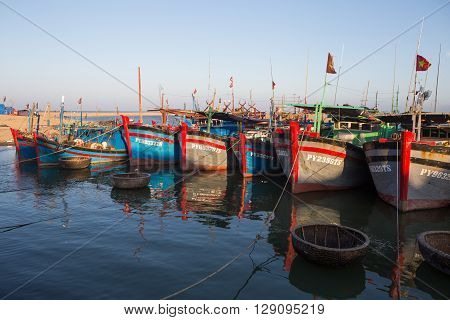 Phu Yen, Vietnam - Apr 22, 2016: Vietnamese wooden fishing boat anchoring at a harbor on a shore in Tuy Hoa beach city, central Vietnam.