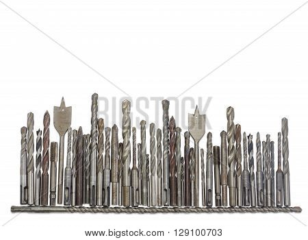 Several old drills and bits different sizes designs for different purposes and with different shapes of shank on a light background