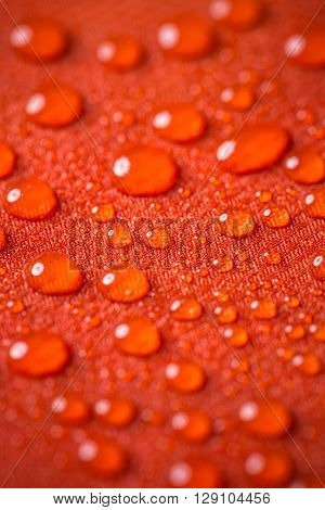 Waterproof textile background with water drops, close up