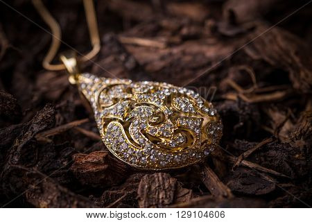 Goldplated pendant with small rhinestones, studio shot