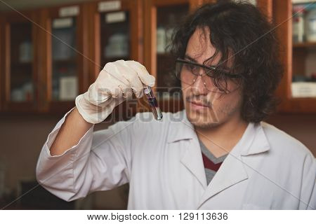 Chemist With Colour Liqiud In Flask