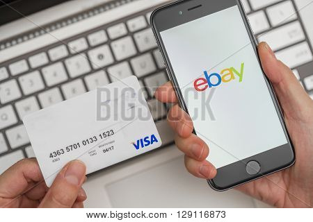 Melbourne, Australia - May 10, 2016: Using eBay app on iphone and credit card for online shopping. eBay is an online auction and shopping website.