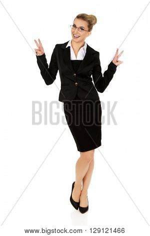 Happy businesswoman showing victory sign