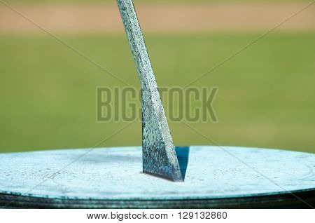 Sundial in the grounds of a garden in bright sunlight