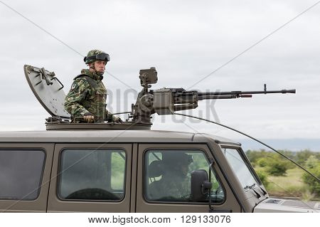 Military Vehicle With Heavy Machine Gun And Soldier