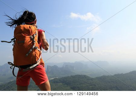 successful woman hiker enjoy the view on mountain top