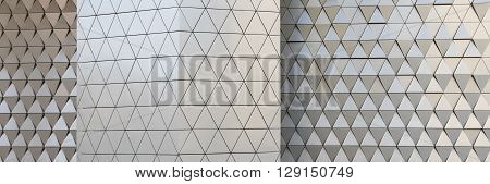Abstract close-up view of modern aluminum ventilated facade of triangles