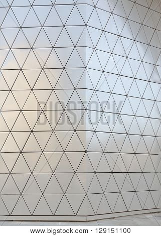 Abstract close-up view of modern aluminum ventilated facade of triangles
