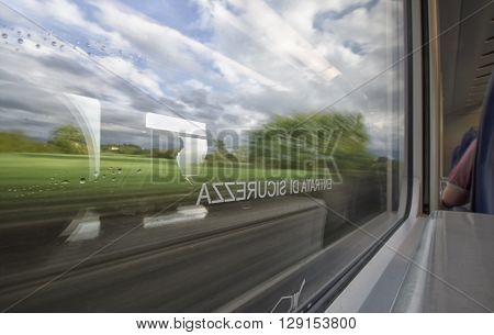 Impressionist landscape seen through the window of the train