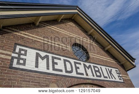 Sign with town name on the railway station of Medemblik