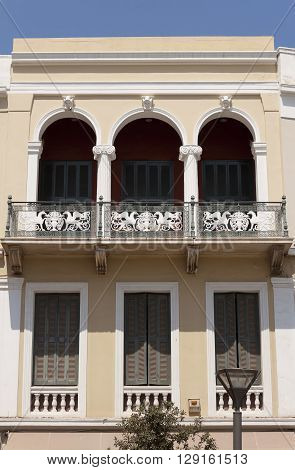 Balconies in old houses of small Greek cities. Heraclion