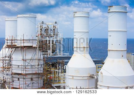 Gas exhaust of gas compressor at top deck with scaffolding of oil and gas processing platform