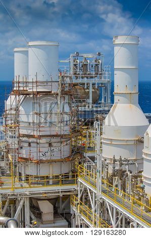 Gas exhaust of gas compressor at top deck with scaffolding of oil and gas processing platform