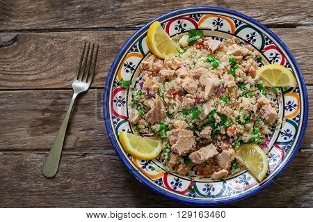 Fresh quinoa and cuscus salad on decorated bowl ready for eat