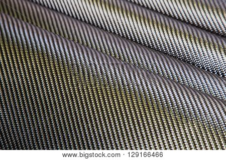 Black woven carbon fiber composite texture for reinforcement car parts.