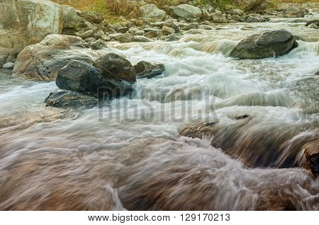 Beautiful Reshi River water flowing through stones and rocks at dawn Sikkim India. Reshi is one of the most famous rivers of Sikkim flowing through the state and serving water to many local people.