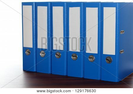 a row with six file folders on desk