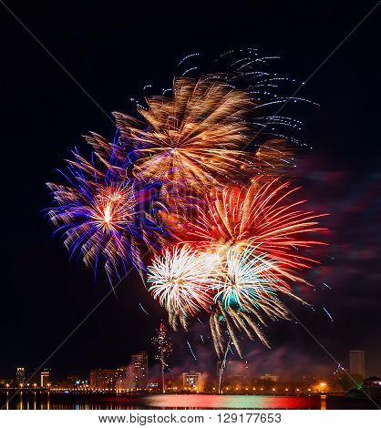 fireworks over night city and city pond Yekaterinburg city center. Celebrating the victory of May 9, 2016