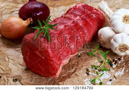 Fresh Raw beef tenderloin steak meat ready to cook with herbs.