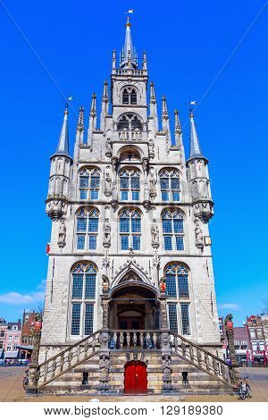 Gouda Netherlands - April 20 2016: old city hall of Gouda with unidentified people. It was built between 1448 and 1450 and is one of the oldest Gothic city halls in the Netherlands