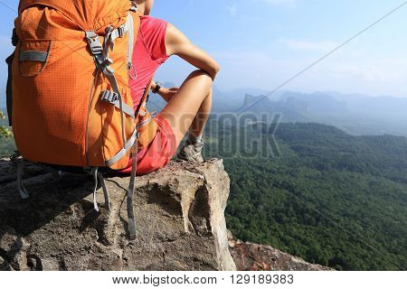 successful woman hiker enjoy the view on mountain top
