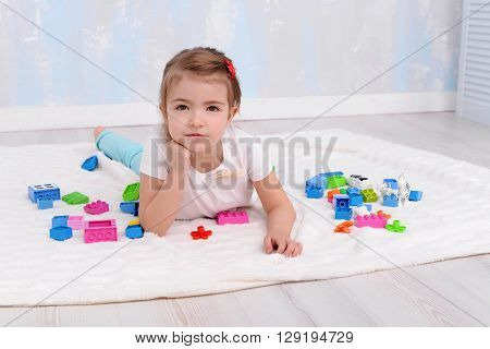 Happy ?hild girl playing with toys constructor