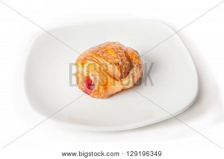 Croissant stuffed with jam on a white plate
