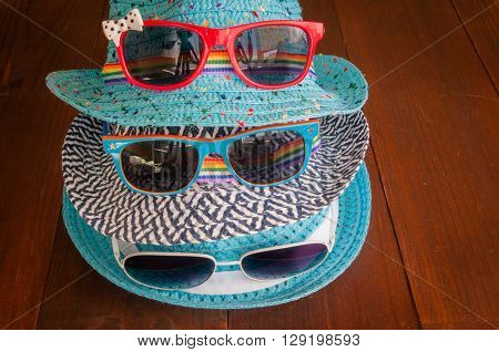 Preparation for traveltrip vacation tourism mock up of road map camerahat sunglasses on wooden table.