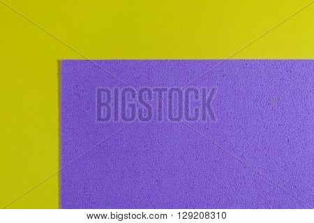 Eva foam ethylene vinyl acetate sponge plush light purple surface on lemon yellow smooth background