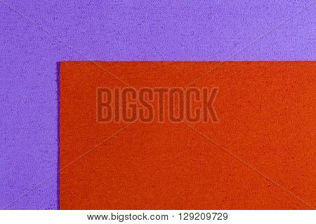 Eva foam ethylene vinyl acetate orange surface on light purple sponge plush background