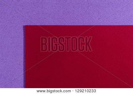 Eva foam ethylene vinyl acetate smooth red surface on light purple sponge plush background
