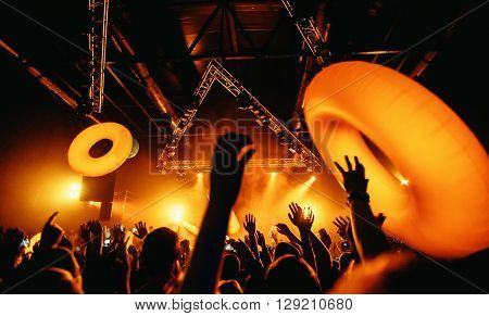 night party festival crowd of people silhouettes hands up