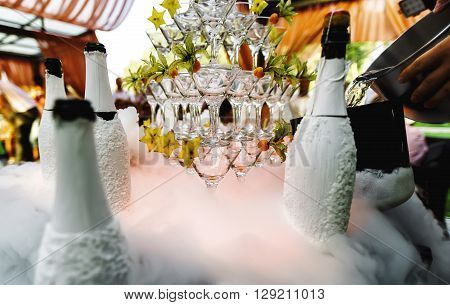 Glasses for feeding alcoholic cocktails in club with yellow light lasers