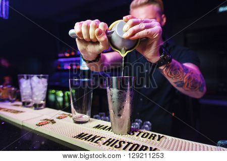 SMOLENSK - 4 OCT: bartender preparation alcoholic cocktail in night club on October 4, 2015 in Smolensk, Russia.