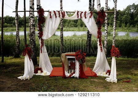 rustic nature wedding arch in red. Country view