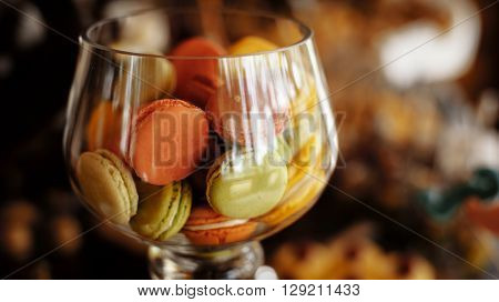 rustic catering service buffet table with delicious sweet food macaroons