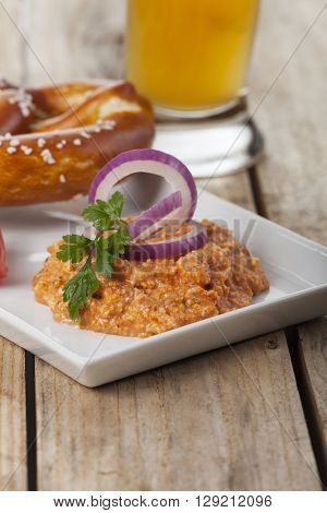 bavarian cheese spread with pretzel on wood