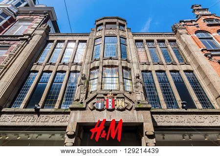 The Hague Netherlands - April 21 2016: historical building with Hennes and Mauritz store. The Hague is seat of the Dutch government and the 3rd largest city of Netherlands with 515880 inhabitants