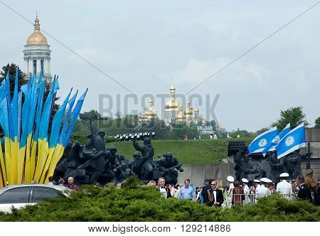 Kyiv, Ukraine - May 8, 2009: Crowd among monuments and flags with churches on the background during Victory Day celebration at the Museum of The History of Ukraine in World War II in Kyiv
