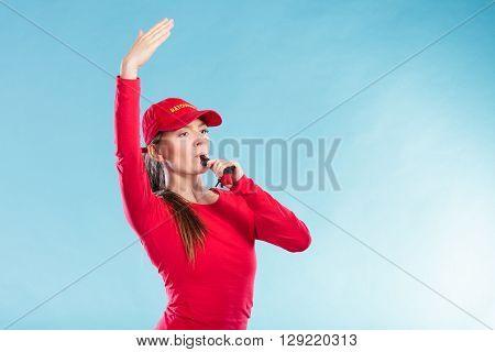 Lifeguard Woman In Cap On Duty Blowing Whistle.