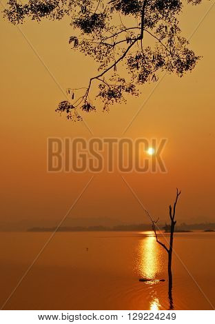Beautiful view shadows Light Long-tailed boat sunrise in dam Srinakarin National park Kanchanaburi Thailand